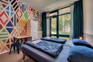 a bedroom with two beds and a mural at Stayokay Hostel Maastricht in Maastricht +46 photos