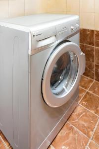 a white washing machine in a kitchen at Corfu Downtown in Corfu