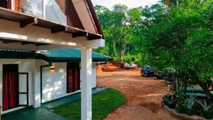 a side view of a building with a parking lot at Mist Mountain Hiking Base in Pimbura