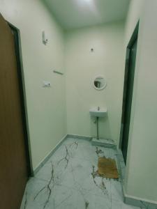 a bathroom with a sink and a toilet at Bheemas Grand Ps9 in Srikalahasti