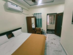 a bedroom with a bed and a room with a window at Bheemas Grand Ps9 in Srikalahasti