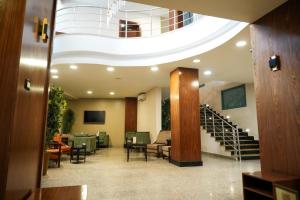 a lobby with a spiral staircase in a building at Attawfeek Hotel in Tripoli
