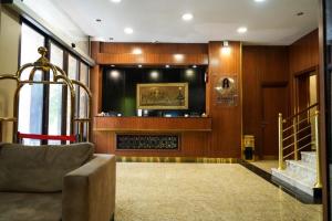 a living room with a couch and a fireplace at Attawfeek Hotel in Tripoli