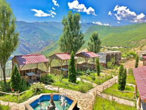 a resort with a pool and mountains in the background at Dzorak in Halidzor