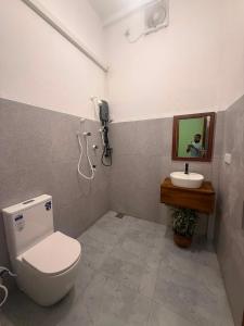a bathroom with a toilet and a sink at Eagle Resort Arugambay in Arugam Bay