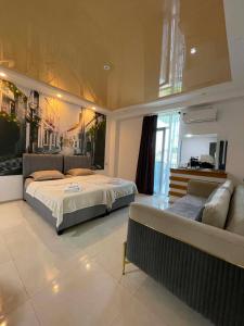 a large bedroom with two beds and a couch at New House Kobuleti 2 in Kobuleti