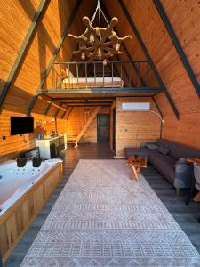 a large living room with a large tub and a couch at Deniz Üstü Bungalov in Fındıklı