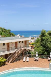 a resort with a swimming pool and the ocean at Casa BACO - Morro de São Paulo in Cairu