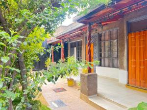 a building with an orange door and some trees at VIJIJI HOTEL & CONFERENCE in Eldoret