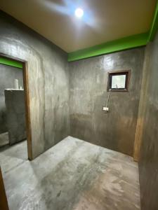 an unfinished room with a window and a wall at Kapunoan Beach House in Burgos