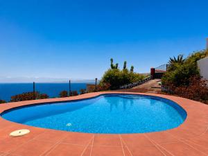 a swimming pool with a view of the ocean at Tomasín in Puntallana