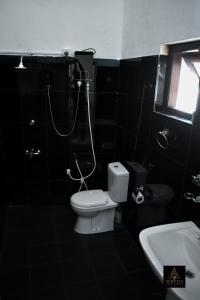 a bathroom with a toilet and a shower at Aurelia Grand Hotel in Kitulgala