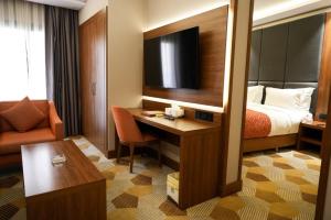 a hotel room with a bed and a desk at Attawfeek Hotel in Tripoli +41 photos