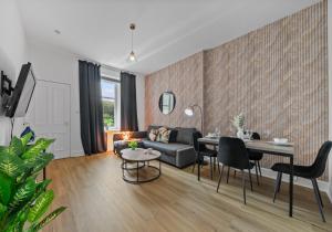 a living room with a couch and a table at Albion Apartment by Klass Living Coatbridge in Coatbridge +19 photos