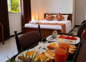 a hotel room with a table with a tray of food at Air Route Transit in Seeduwa