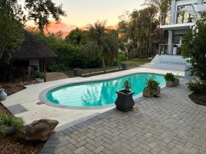 a swimming pool in the backyard of a house at House Foxglove in Paarl
