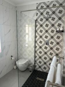 a bathroom with a shower with a toilet in it at House Foxglove in Paarl +5 photos