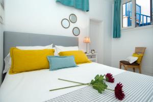 a bedroom with a bed with yellow and blue pillows at Famara Marea 2 in Famara