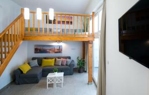 a living room with a couch and a loft at Famara Marea 2 in Famara