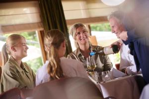 a man pouring a glass of wine for a group of people at Landgoed De Holtweijde in Lattrop