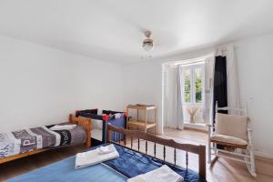 a bedroom with two bunk beds and a chair at Logis des gourmets in Hommes