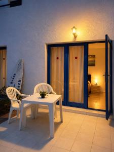 a white table and two chairs on a patio at Los Barqueros Suites Palm in Corralejo