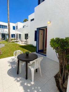a table and two chairs on a patio at Los Barqueros Suites Palm in Corralejo