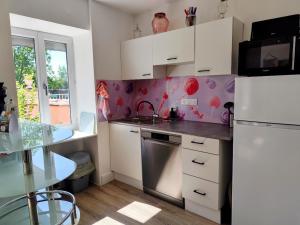 a kitchen with a sink and a refrigerator at Candyland in Argançon