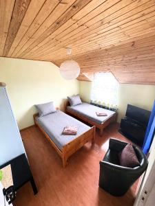 a living room with a bed and a couch at Asetech Sandra in Pasym