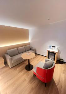 a living room with a couch and a table at Ivy Hotel Lagos Ikeja in Hausa