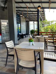 a table and chairs with flowers on it in a restaurant at New House Kobuleti 2 in Kobuleti