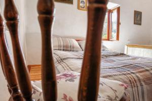 a bedroom with a bed and a bed frame at Kuca za odmor Lipa in Sinac