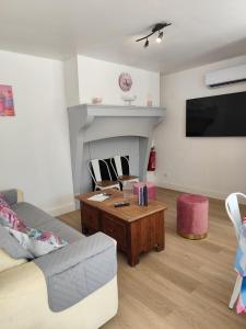a living room with a couch and a coffee table at Candyland in Argançon