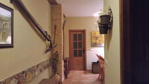 a hallway of a house with a staircase and a door at Casa de dos habitaciones con piscina en Cabañeros in Navas de Estena