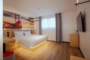 a hotel room with a large bed and a window at Ivy Hotel Lagos Ikeja in Hausa
