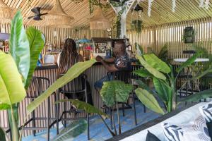 a man sitting at a bar in a restaurant at Hidden Gem Barbados in Christ Church