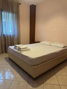 a bedroom with a bed with towels on it at Villa Malila in Panagia
