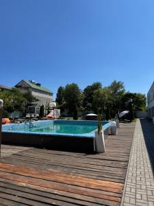 a large swimming pool on a wooden deck at Вілла с басейном in Zatoka