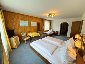 a hotel room with a bed and a living room at Sporthotel Flachauwinkl in Flachau +36 photos