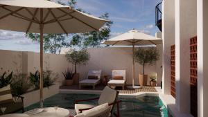 a patio with chairs and umbrellas and a pool at Eendracht Hotel in Stellenbosch +10 photos