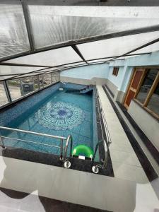 an overhead view of a swimming pool in a building at Nature Palace Farmstay in She