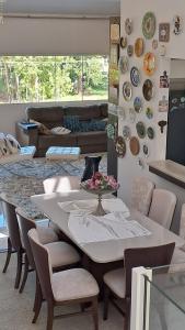 a dining room with a table and chairs and a couch at Conforto em Pomerode in Pomerode