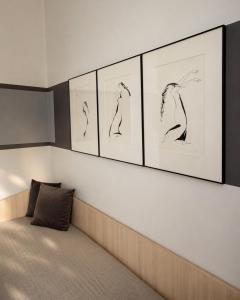 a room with four drawings on the wall at Palangos Dailė in Palanga