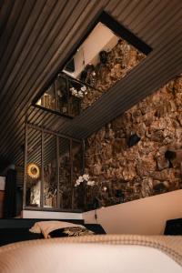 a room with a stone wall with a window at Sweet Loft Grenoble-Love Room avec jacuzzi & sauna in Grenoble +12 photos