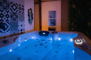 a jacuzzi tub in the middle of a room at Sweet Loft Grenoble-Love Room avec jacuzzi & sauna in Grenoble