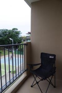 a chair sitting on a balcony looking out at a pool at Amori Spaces - MGD in Suba