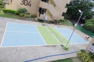 a tennis court in front of a building at Amori Spaces - MGD in Suba