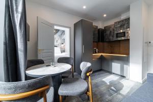 a room with a table and chairs and a kitchen at Maison Astéria in Nice +121 photos