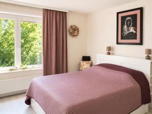 a bedroom with a bed and a window at apartment 2 miles from Maastricht in Lanaken