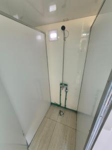 an empty room with a shower in the wall at Willage camp i auto camp KOMARNICA in Šavnik +11 photos